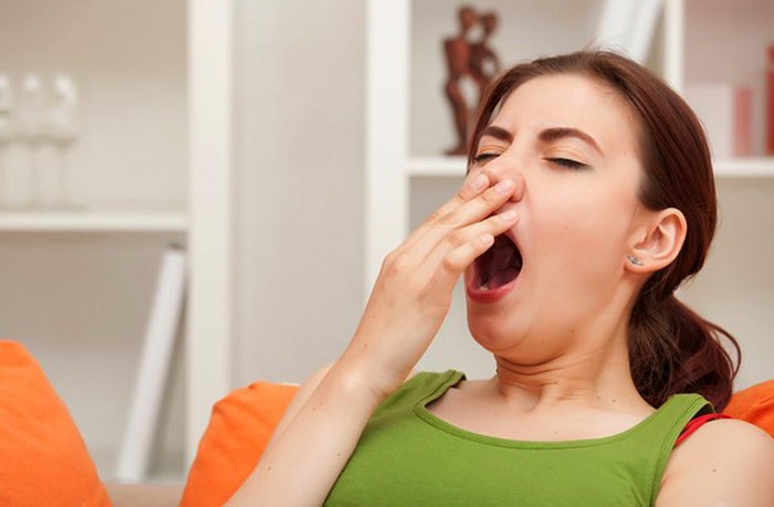 Женщина зевает